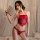 A woman poses elegantly in a red lace lingerie set featuring a halter top and matching thong, holding a decorative fan. the d...