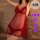 Model wearing red sheer plus size lingerie sleep set with polka dots and feather trim for date nights.