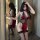 Woman modeling red lace cheongsam-style lingerie set with flirty neckline and hook-on nightgown design, paired with black sto...