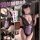 Model wearing purple lace maid costume with deep v neckline and black trim, featuring bustier top, garter straps, and matchin...