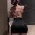 Woman wearing floral mesh top and black bodycon skirt, showcasing a curvy silhouette in an office-chic outfit.