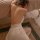 Woman wearing plus size deep v neck sleep dress with sheer mesh backless design, elegant lace trim nightwear.