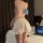 Woman wearing a plus size sexy maid costume featuring a checkered backless dress with a flirty petticoat and lace trim.