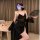 A woman poses elegantly in a black lace bralette sleepwear set, featuring sheer cami design and floral embroidery. she holds ...