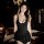 Woman wearing black plus size sexy zipper crotch skirt in dimly lit bedroom, showcasing seductive outdoor lingerie for couple...