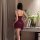Woman wearing burgundy lace-back sleepwear set with adjustable ties, showcasing premium ice silk fabric and elegant silhouett...