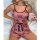 A woman lounges on a bed wearing a pink pure & alluring womens sleepwear set featuring crown patterns, paired with a pearl ne...