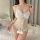 Woman wearing white lace lingerie set with bow detail, sheer bodice, and fluffy trim – pure & playful lingerie set.