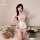 A woman poses in a pink nurse-themed sleepwear set, featuring sheer fabric and lace details, perfect for a playful yet elegan...