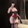 Woman wearing pure & playful lingerie set with sheer lace bra, thong, and stockings in red and black.