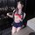 Woman in cute student-style sleepwear with lace blindfold, red bow, and pleated skirt — pure & seductive lingerie set for fli...