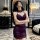 A woman poses elegantly in a luxurious room, wearing a purple lace bodysuit from the pure & seductive lingerie set. the modes...