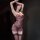 Woman in purple lace lingerie with steel-ring details, featuring a bra and matching garter belt for sensual elegance.