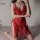 A woman poses wearing a red lace sleepwear set, featuring intricate patterns and delicate fabric, perfect for a romantic midn...