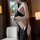 Woman wearing black pure temptation lingerie set, featuring a seductive halter top and high-cut bottoms with side cutouts.