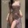 Woman modeling a sheer purple lace qipao lingerie set with high slit, off-shoulder design, and delicate floral embroidery — e...