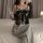 Woman wearing pure & tempting lace lingerie set with sheer bodice, bow detail, and matching gloves, holding champagne flute o...