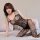 Woman modeling black lace bodysuit with mesh details and open-crotch design on bed.