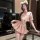 A woman poses wearing a qingshe jk lingerie set featuring a pink pleated skirt, sailor-style top with bow, and cat ears headb...