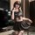 A woman poses wearing a black qingshe jk lingerie set, featuring a pleated skirt and sailor-style top with a bow detail. the ...
