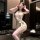 Woman wearing qingshe lace lingerie set, elegant secretary-style bodysuit with lace trim and garter straps, posing indoors.
