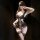 Woman wearing black lace lingerie set with sheer bust-out design, featuring intricate floral patterns and matching garter sto...