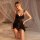 Woman wearing black qinmu sexy lace lingerie set with sheer mesh cami and briefs, posing on bed with white drapes.