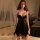Woman wearing qqny black lace lingerie set with underwire push-up bra and matching panty, kneeling on bed in sensual pose.