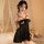 A woman poses in a black sheer mesh sleep dress featuring lace detailing, an underwire bra, and a bow at the back, perfect fo...