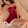 A woman lounges on a bed wearing a festive red ruolan christmas lingerie set, featuring a plush velvet cami sleep dress with ...