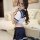 Woman modeling sexy sailor uniform cosplay costume with navy skirt and white crop top, perfect for adult role play lingerie s...