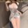 Woman wearing a white satin sleep dress with ties, showcasing its alluring design perfect for summer lounging or intimate nig...