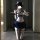 A person poses in a mirror wearing a new schoolgirl jk uniform lingerie set, featuring a white bra with blue accents and a na...
