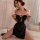 A woman poses in a black gold tassel mandarin collar chinese-inspired lingerie set featuring a high-waist slit and qipao desi...