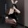 Woman in black secretary bunny girl lingerie set with lace gloves, ears, and heels, posing seductively for role play.