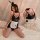Seductive maid costume lingerie set with black shiny fabric, white apron, and bunny ears headband.