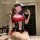 Woman in red and black maid costume with white lace trim, cat ears, and thigh-high stockings, posing for selfie.