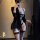 Woman wearing black seductive open-crotch bondage bodysuit with sheer panels and garter straps, paired with a blazer.