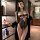 Woman modeling black lace bodysuit and robe in modern bedroom. seductive womens lingerie set for intimate moments.