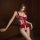 Woman wearing red lace bodysuit with sheer panels and open-crotch design, enhancing curves with elegant, sensual style.