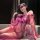 Woman in purple sheer mesh lingerie set with lace, high-end stockings, and eye mask—sensual, playful elegance.