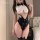 Woman wearing a sexy bunny costume with a white collar, black bow tie, and one-piece bodysuit featuring cutouts and button de...