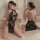 Woman modeling black lace bodysuit with sheer cheongsam design, featuring vintage-inspired cutouts and adjustable ties.