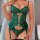 Woman wearing emerald green lace bodysuit with sheer mesh, heart-shaped clasps, and garter straps. wire-free sensual lingerie...