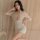 Woman wearing a sexy lace lingerie set with short sleeves, featuring a deep v-neck and high-waisted design, perfect for sleep...
