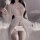 Woman in white lace sheer sleepwear set with open-crotch bodysuit, holding a rose. seductive uniform-inspired intimate wear.