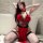 Woman wearing red lace backless cheongsam-style nightgown with cutouts and thigh-high stockings, posing seductively on floor.