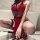 Woman wearing red lace sleepwear with black accents, backless cutout design, and thigh-high stockings.