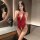 Woman wearing red lace open-crotch bodysuit, sheer temptation lingerie set with deep v-neck and delicate floral detailing.