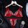 Red lace lingerie set with sheer romantic design, featuring a bra and thong on a hanger with pearls and decorative stones.